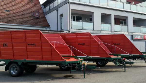 a large red trailer in a field